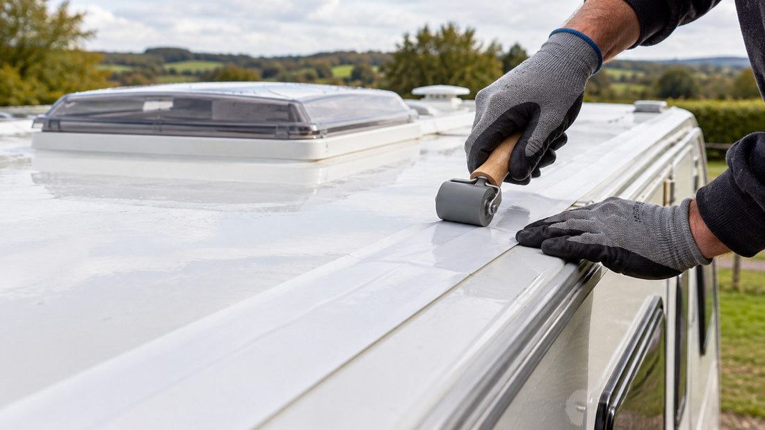 Sealing a caravan roof joint with white tape and a seam roller